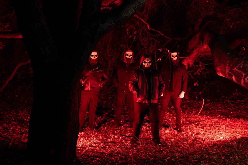 Wrath of Logarius band photo featuring haunting forest scene and skull masks. Season of Mist promo shot by David Gravelle