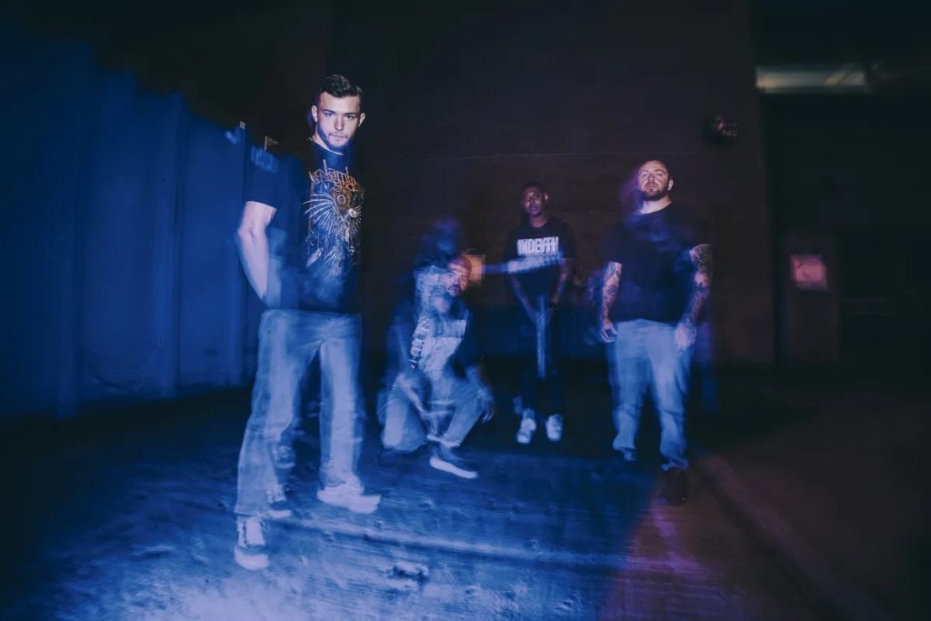 “This Dying Hour band members pose together in a 2025 promotional photo by Robin ‘Dobbin’ Thomas, showcasing their UK metalcore aesthetic.”