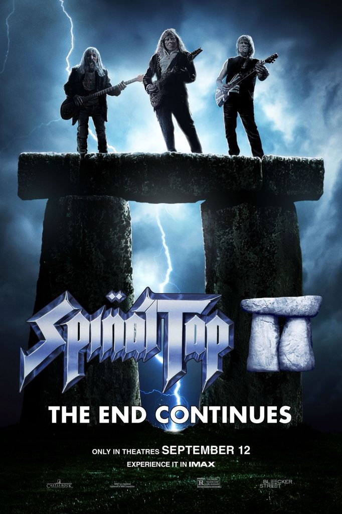 “Official poster for Spinal Tap II The End Continues featuring the three band members standing on a Stonehenge-like rock formation with electric guitars under a stormy sky with lightning. Text reads: ‘Spinal Tap II: The End Continues – Only in Theatres September 12 – Experience it in IMAX.’”