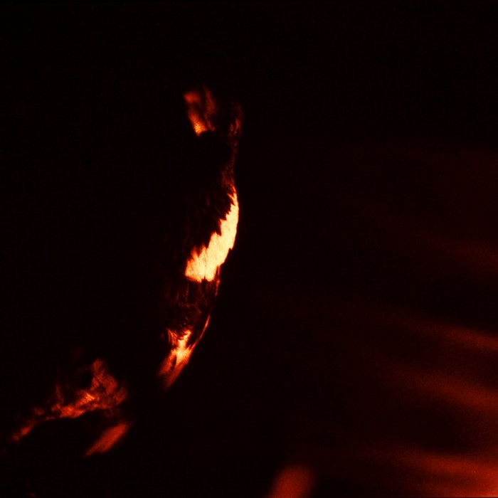 Album cover of Skepticism's 1995 release Stormcrowfleet, featuring dark, abstract red and black imagery with shadowy forms.