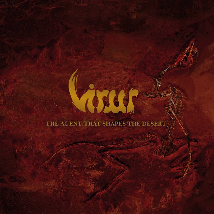 Album cover for Virus’s The Agent That Shapes the Desert, featuring skeletal remains of a lizard-like creature embedded in a red, desert-like background with the band’s gold logo above.