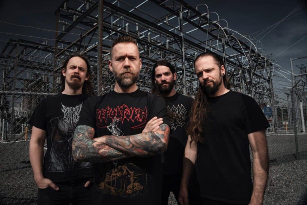 Revocation band photo 2025, standing in front of an industrial power grid