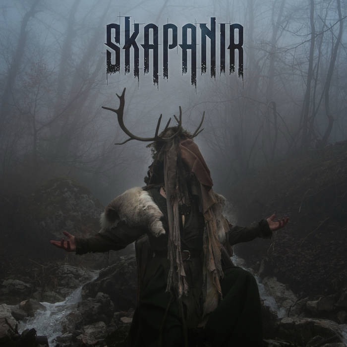 Danheim – Skapanir album cover featuring a hooded figure with antlers in a misty forest