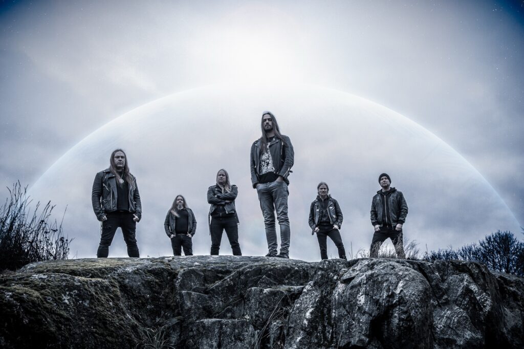 World Metal Weekly featured image of …And Oceans Finnish symphonic black metal band promo photo standing on rocky landscape