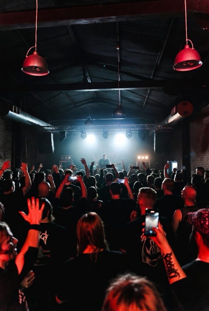 Underground metal concert crowd in a small venue, hunting metal was bloodsport era energy.