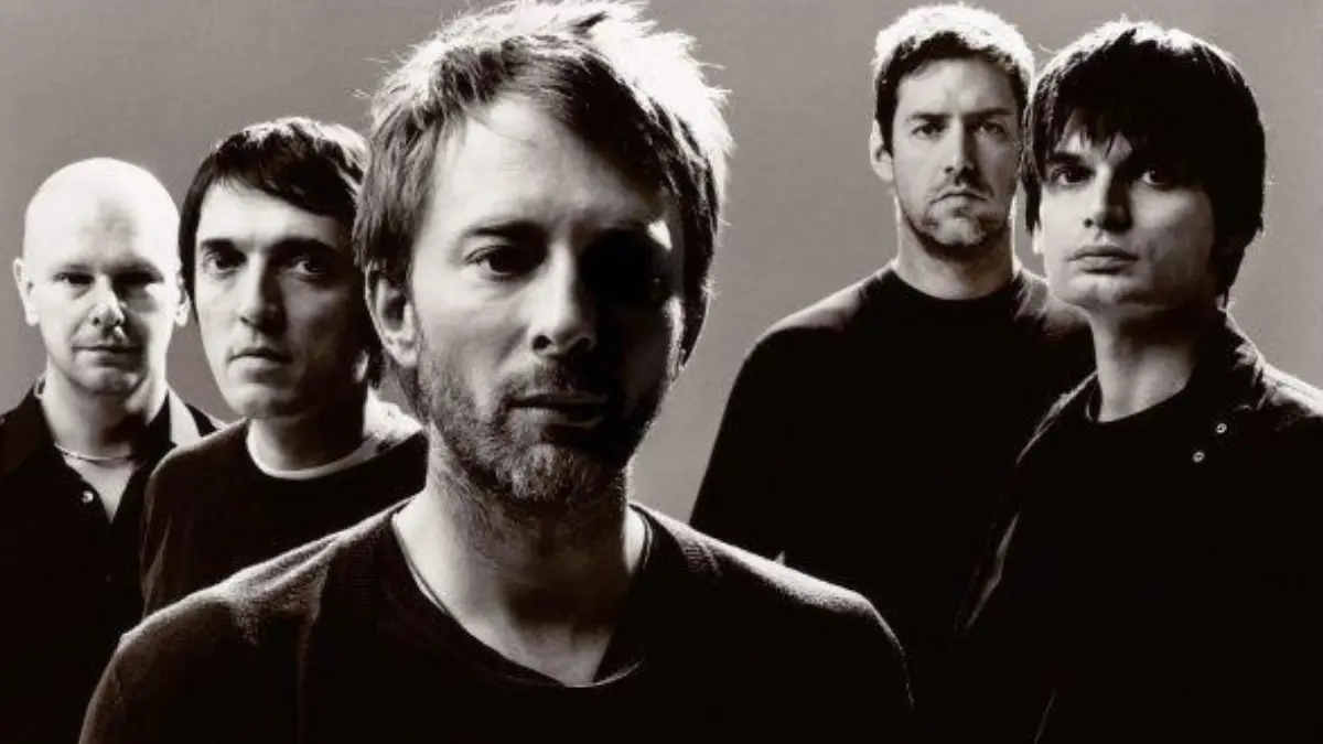 Black and white promotional photo of Radiohead band members standing together against a plain background.