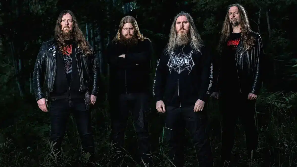 Vomitory Swedish death metal band members standing in forest 2026