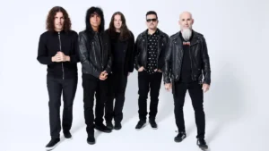 Anthrax band members posing together in black clothing against a white studio background during the Cursum Perficio era.