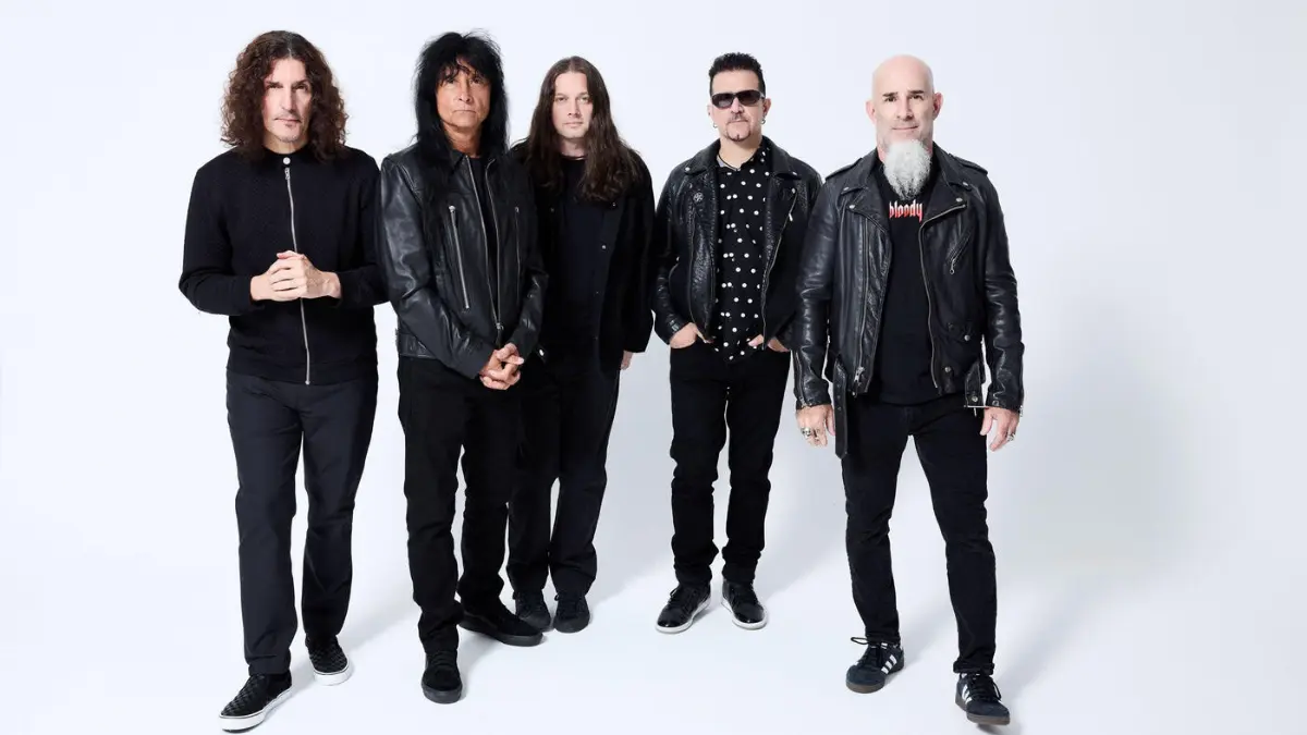 Anthrax band members posing together in black clothing against a white studio background during the Cursum Perficio era.