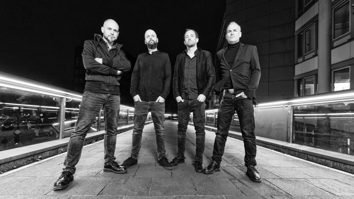 Swiss industrial black metal band Samael posing in a black and white nighttime city photo for World Metal Weekly Switzerland edition