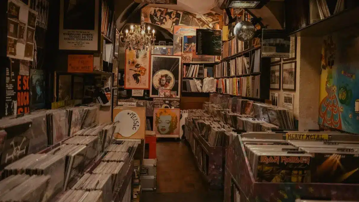 Interior of an independent record store filled with vinyl albums, shelves of records, framed artwork, and classic rock and metal releases.