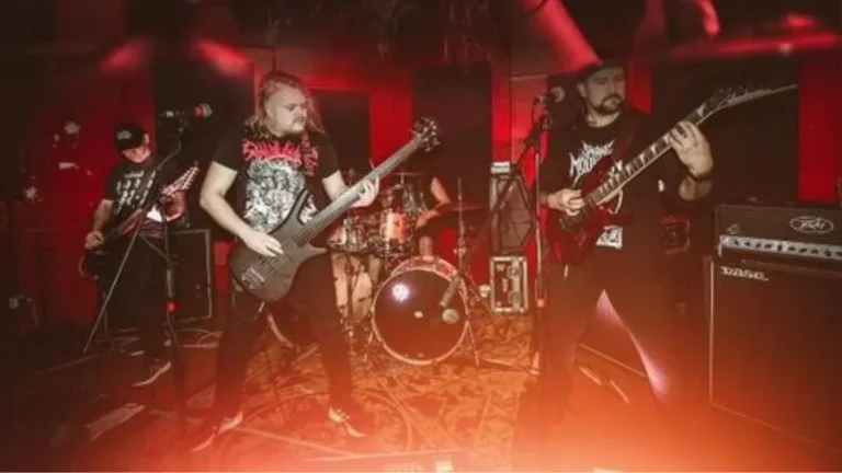 Awful Noise performing live with vocalist, guitarists, bassist, and drummer under red stage lighting.