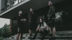 Lithuanian sludge metal band Erdve posing on concrete steps outside a modern building in a dark promotional photograph.