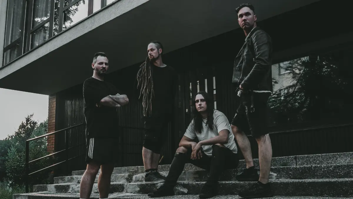 Lithuanian sludge metal band Erdve posing on concrete steps outside a modern building in a dark promotional photograph.