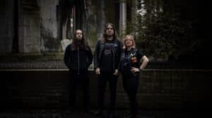 British doom metal band Witchsorrow posing outside a weathered Gothic stone building ahead of the release of The Devil and All His Works.