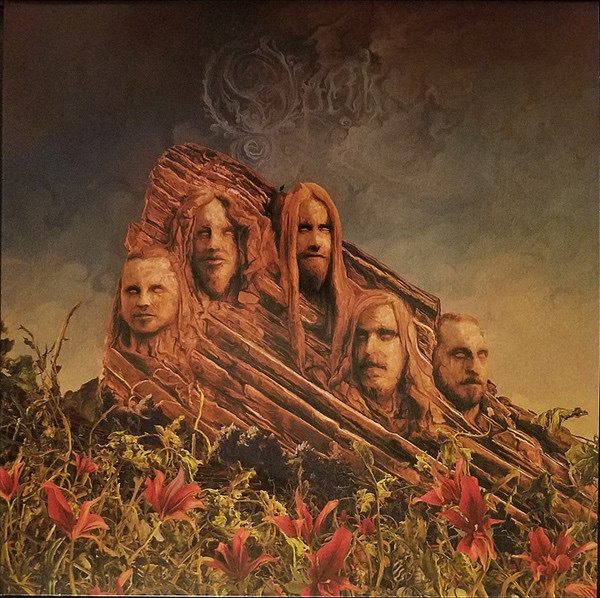 Opeth Garden of the Titans album cover depicting a gothic stone mansion with glowing windows, a horse-drawn carriage, and shadowy figures.