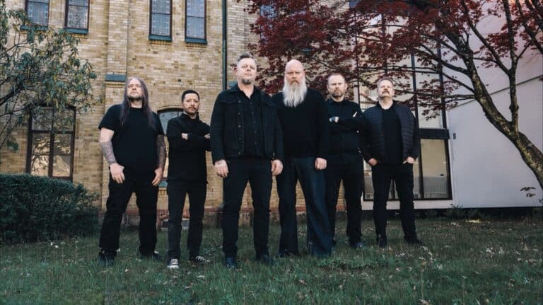 Green Carnation band members pose outside a historic church before the release of A Dark Poem, Part III: The Messiah Complex in 2026.