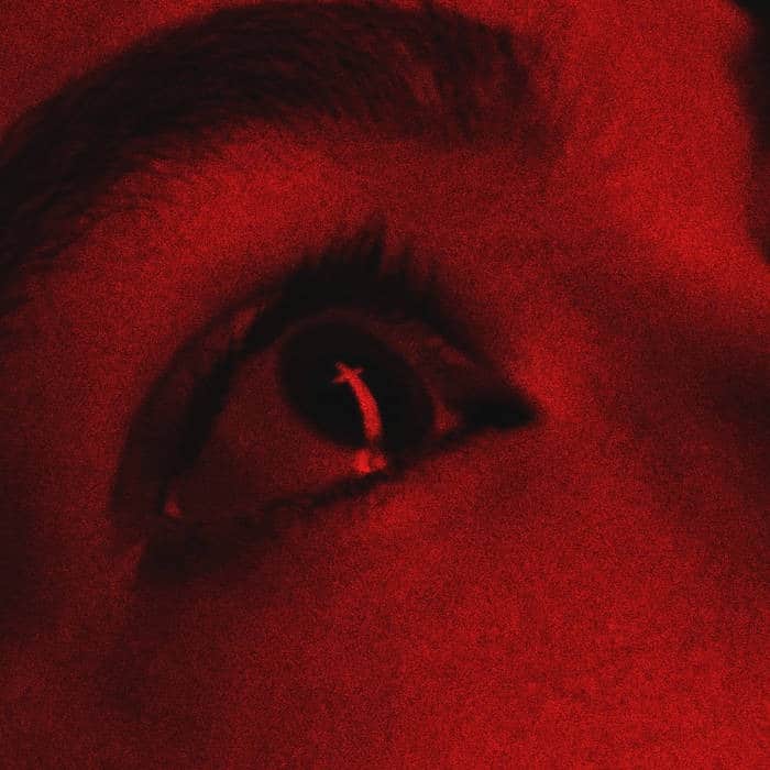 The Forest Forgets Godweight album artwork for “Pirouette,” featuring a close-up human eye rendered in deep red and black