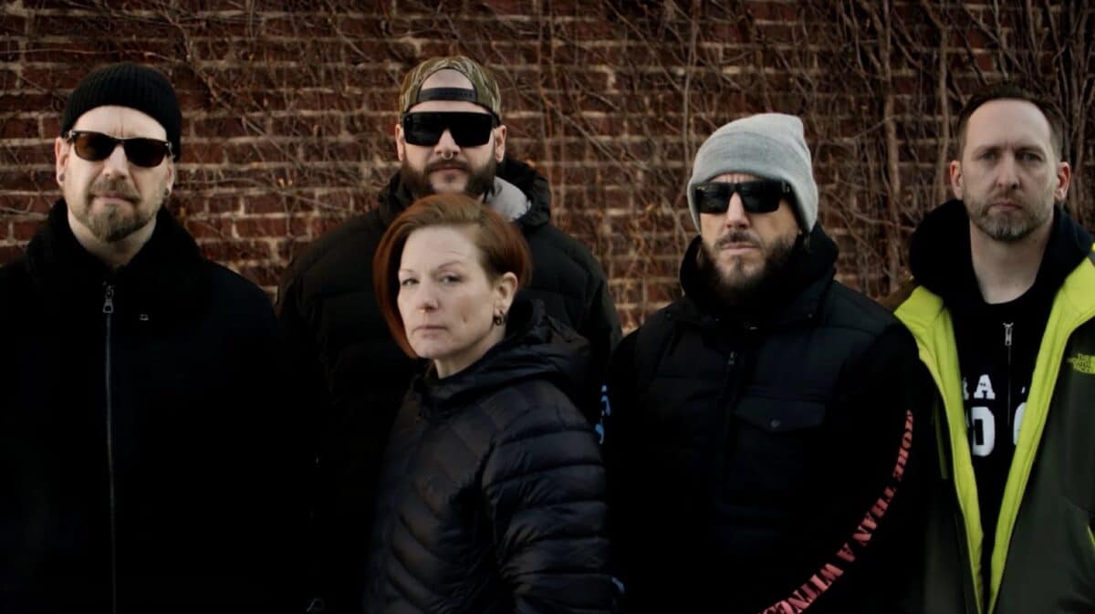 Walls of Jericho True Til Death promotional band photo featuring vocalist Candace Buckingham and four band members standing against a brick wall.