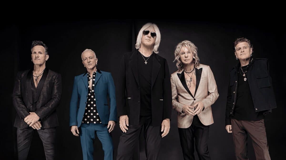 Def Leppard 2027 tour promotional band photo featuring the five members of the British rock band.