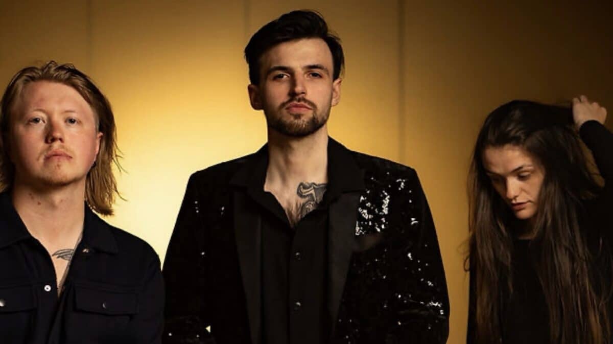 Fail The Enemy Sandcastles EP Review – promotional photograph of the UK alternative metal trio against a warm golden background.