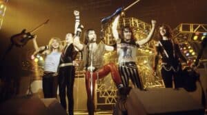 Iron Maiden North American Tour 2027 news featuring an archival concert photograph of the British heavy metal band performing onstage.