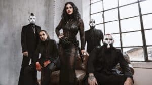 Lacuna Coil Fragile XX – Official band promotional photo featuring Cristina Scabbia and her bandmates dressed in black in an industrial setting.