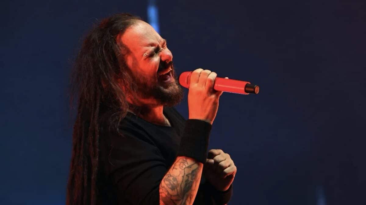 Sonic Temple 2027 Lineup headliner Jonathan Davis of Korn performing live onstage with a red microphone.