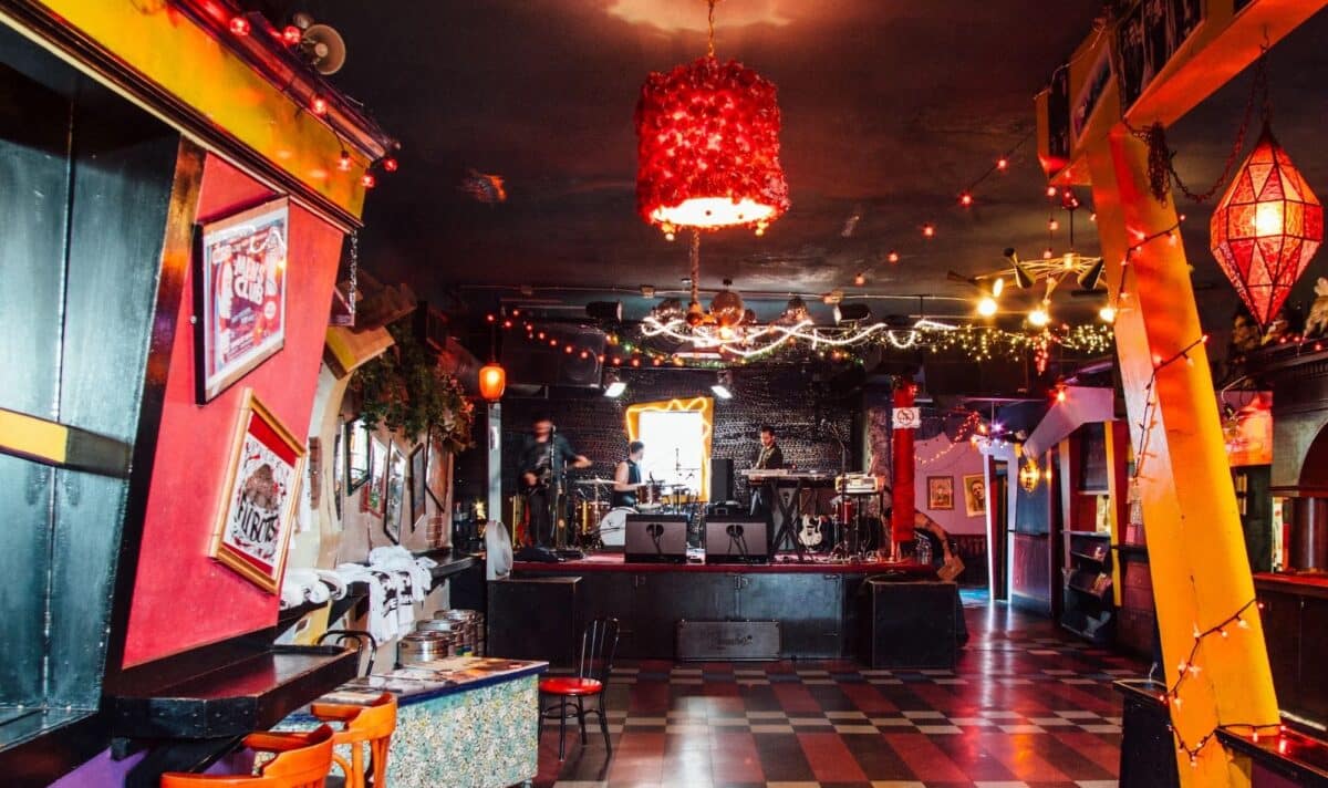 Interior of Bottom of the Hill in San Francisco showing its intimate concert stage, colorful lighting, checkered floor, and vintage music club atmosphere.