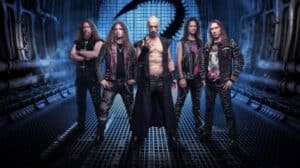 Beast in Black 2027 North American tour featured band photo showing five members standing in a blue-lit futuristic industrial corridor.